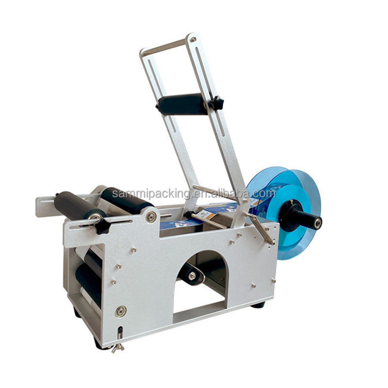 MT-50 Etichettatrice semiautomatica per etichette adesive per bottiglie e vasetti rotondi per imballaggi in metallo, carta e vetro, uso alimentare - Nuovo/Usato