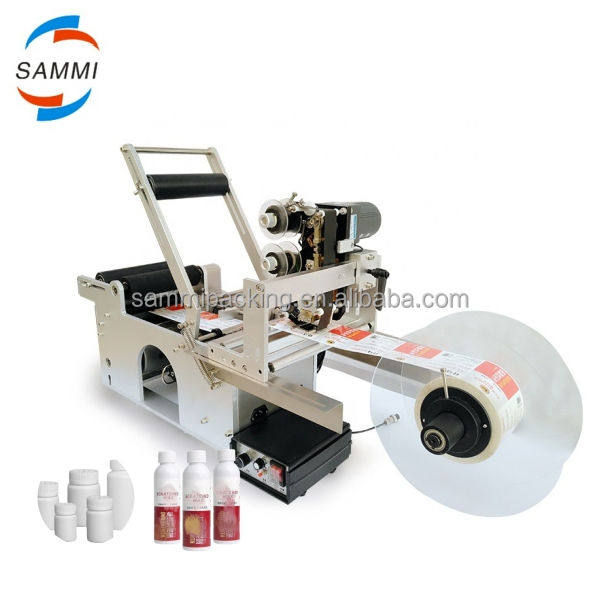 MT-50 Etichettatrice semiautomatica per etichette adesive per bottiglie e vasetti rotondi per imballaggi in metallo, carta e vetro, uso alimentare - Nuovo/Usato